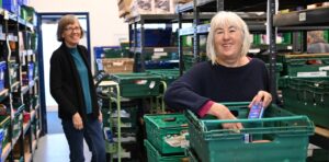 Smiling volunteers working in the food bank