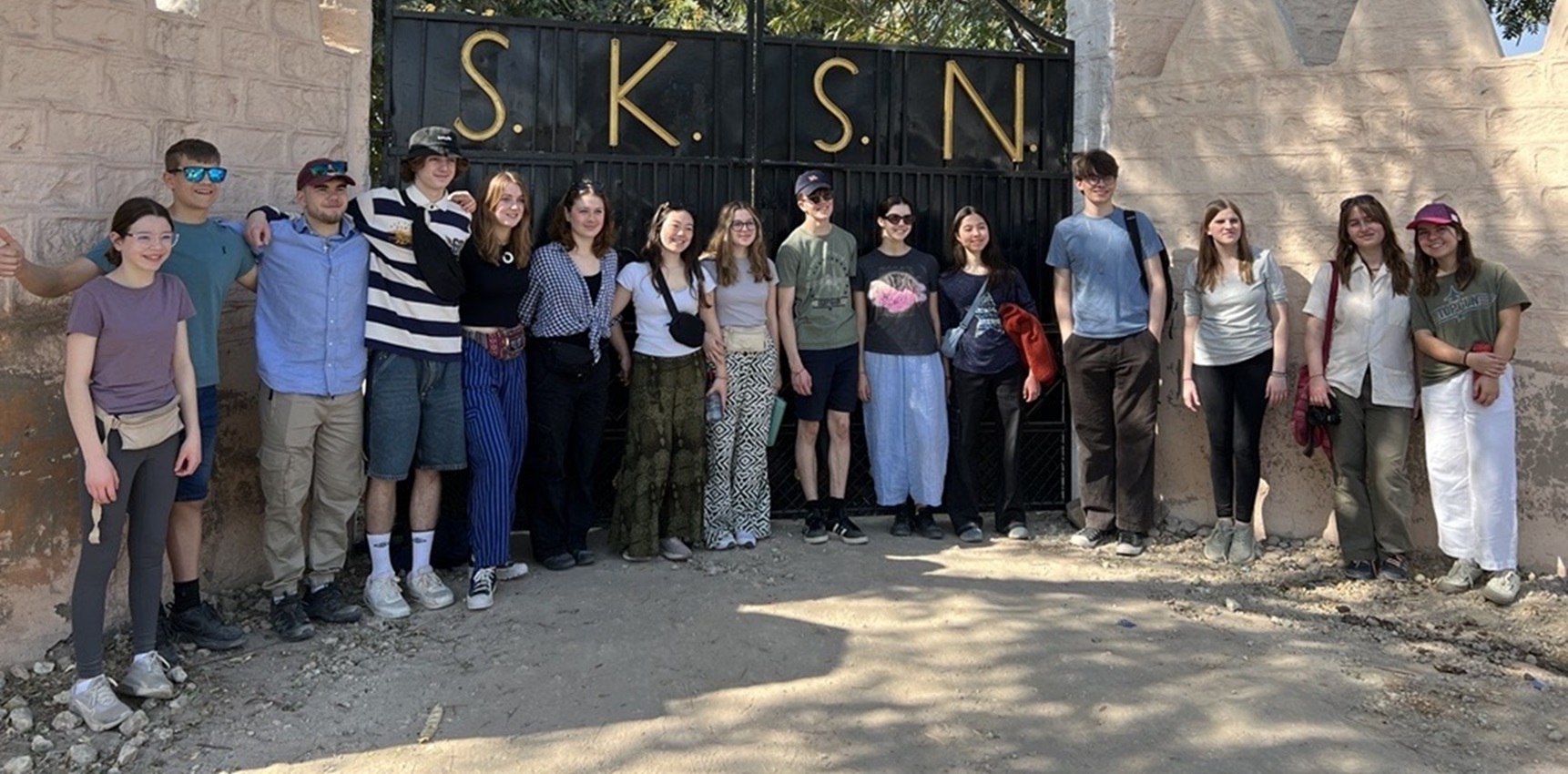 Impington Village College students at the gates of the school they visited in India