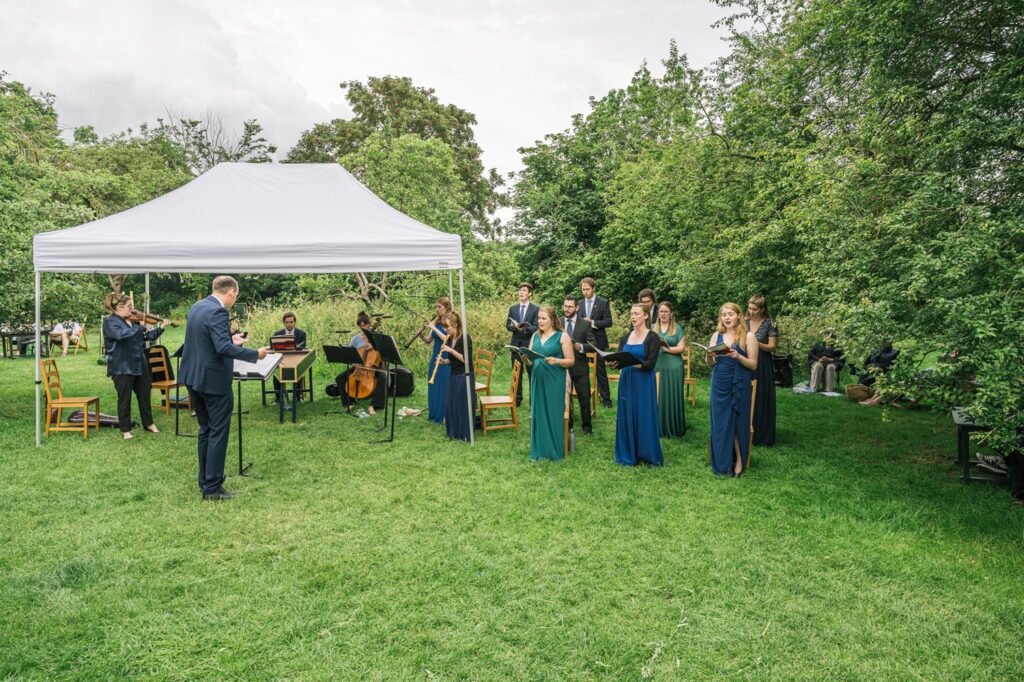 Ebacorum Baroque players and singers performing in a garden setting