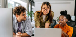 Students gathered around a laptop computer